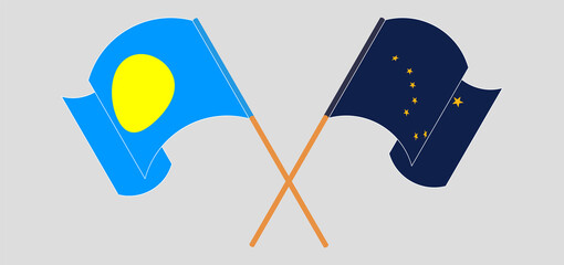 Crossed and waving flags of Palau and the State of Alaska