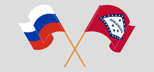 Crossed and waving flags of Russia and The State of Arkansas