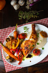 Rustic fried chicken legs with assorted vegetables and rice