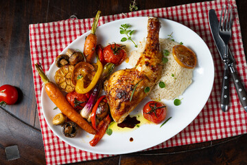 Rustic fried chicken legs with assorted vegetables and rice