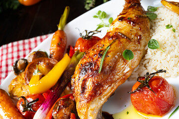Rustic fried chicken legs with assorted vegetables and rice
