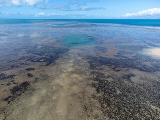 Amazing coral reef in the middle of the sea in Porto Seguro, Bahia, Brazil - natural beauty aerial drone view