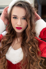 Beauty girl in santa costume at winter campsite getting ready for the new year. New year celebration concept