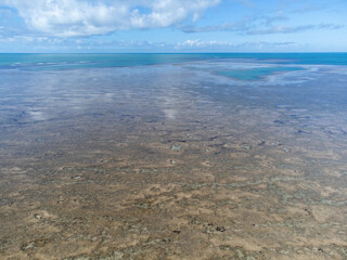 Amazing coral reef in the middle of the sea in Porto Seguro, Bahia, Brazil - natural beauty aerial drone view