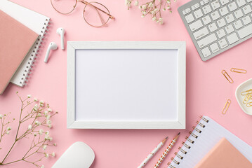 Business concept. Top view photo of workplace photo frame keyboard computer mouse notebooks clips pencils glasses earbuds white gypsophila flowers on isolated pastel pink background with copyspace