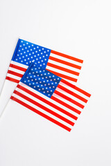 USA Independence Day concept. Top view vertical photo of two national flags on isolated white background