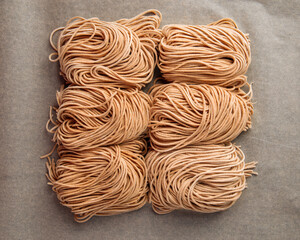 Raw handmade noodles on the parchment paper