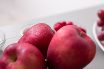 Fresh apples in glass bowl on kitchen counter, healthy food for diet.