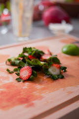 Strawberries cuttings on chopping board in kitchen, healthy lifestyle concept.