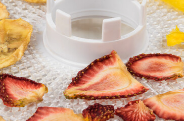 dried strawberry pieces on a white lattice, close-up
