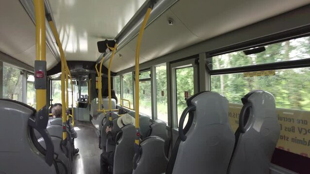 The interior of a near empty coach winding through a country lane in England