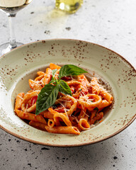 Side view on portion of seafood penne pasta dish