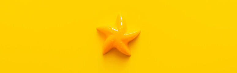 top view of bright starfish toy on yellow background, banner. - obrazy, fototapety, plakaty