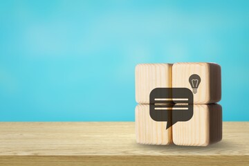 Wooden cube with feedback, idea, strategy symbols on desk