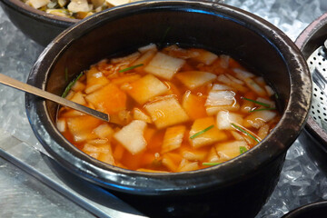 Water kimchi, a type of kimchi, is made by slicing radish thinly, then adding red pepper, green onion, and garlic and pouring the broth.