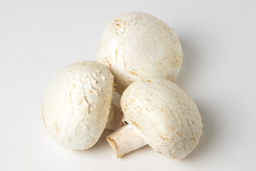 Champignon mushrooms on a white background. Delicious and healthy vegetable. Vegetarian food