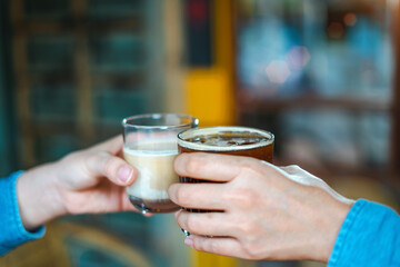 Close up of young couple hands clinking or toasting glasses of coffee talking sharing showing love and care, support, and Cheers, or business dealing, leisure time with friends idea. For Copy Space