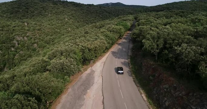 Aerial view of old Volkswagen 1990 Golf Cabrio travels in mountainous terrain