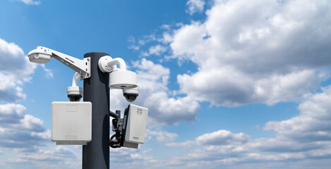 Security camera against blue sky