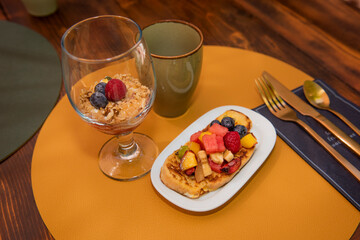 Mediterranean breakfast outdoors in the courtyard of a house with fruit toast