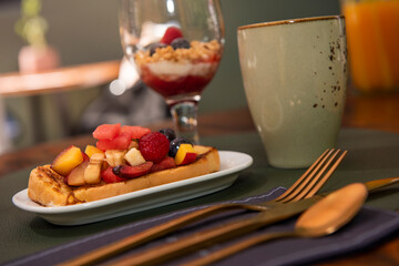 Mediterranean breakfast outdoors in the courtyard of a house with fruit toast
