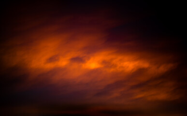 Bright orange sky at sunset, low key. Warm tones.