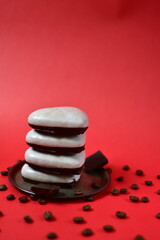 a stacks of gingerbread cookies with chocolate and coffee beans on a red background