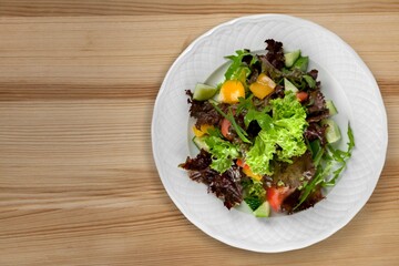 Fresh spring vegetable salad with tomatoes and peppers in the bowl.