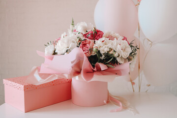 Bouquet of peonies and gift pink box, birthday concept