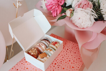 Gift set, macaroons and a bouquet of flowers