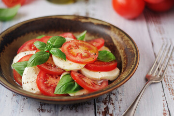 A bowl with traditional Italian caprese salad	