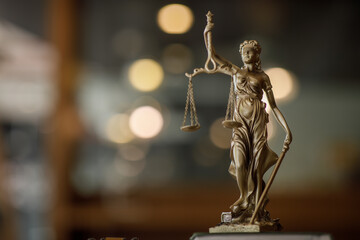 Statue of Lady Justice with scales of justice and wooden judge gavel on wooden table. Panoramic...