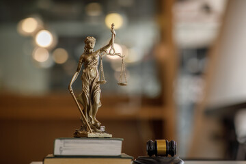 Statue of Lady Justice with scales of justice and wooden judge gavel on wooden table. Panoramic image statue of lady justice.Legal and law concept. 