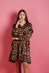 Nice woman in dress at pink background.