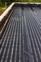 Fototapeta na wymiar Vapor barrier welded with flame on new flat roof against condensation