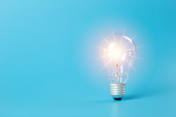 Economical energy concept. light bulb on blue background. electricity power innovation. Energy...