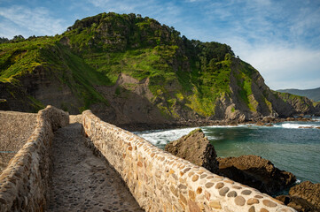 Stone footpath to famous landmark and film location in North of Spain, ocean islet with chapel San juan de gaztelugatxe, Basque Country, Spain