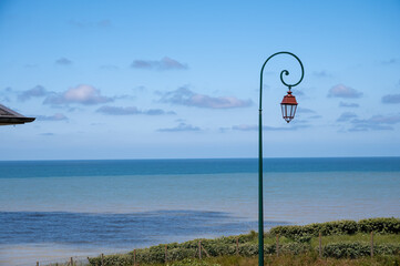 View on blue water of Atlantic ocean near small village Veules-les-Roses, Normandy, France. Tourists destination.