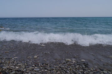 Mediterranean sea coast line with pebbles beach and waves