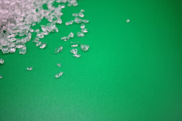 Crushed glass in the left corner on a green background with area for text