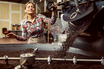 A female coffee factory worker roasting coffee and sentencing it.