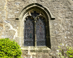 Arched stone window, with stained glass, in a Medieval Church situated in, Long Preston, Skipton, UK