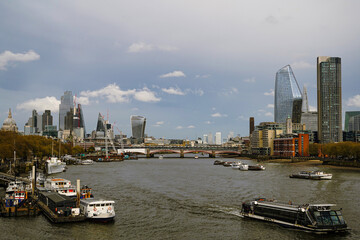 The London Skyline including St. Pauls Cathedral with the Thames and some Boats in the foreground.