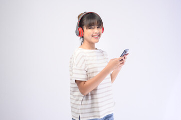 Fototapeta premium Young beautiful woman wearing headset on white background
