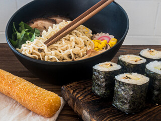 Japanese food. Traditional Ramen bowl and sushi maki