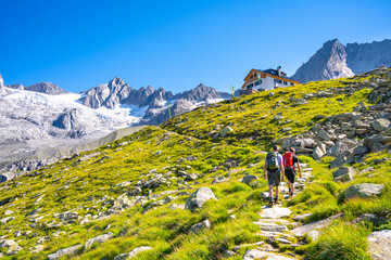 Two hikers ascending mountain hut