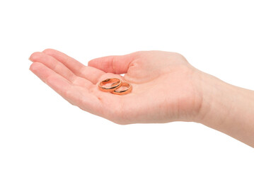 Two golden rings in a woman hand isolated on a white background.