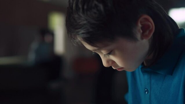 Schoolboy surfing social media communicating with friends using tablet close up.