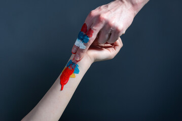 russia vs ukraine concept. russia paints the flag of ukraine with blood