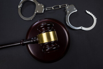 judge's gavel and handcuffs on